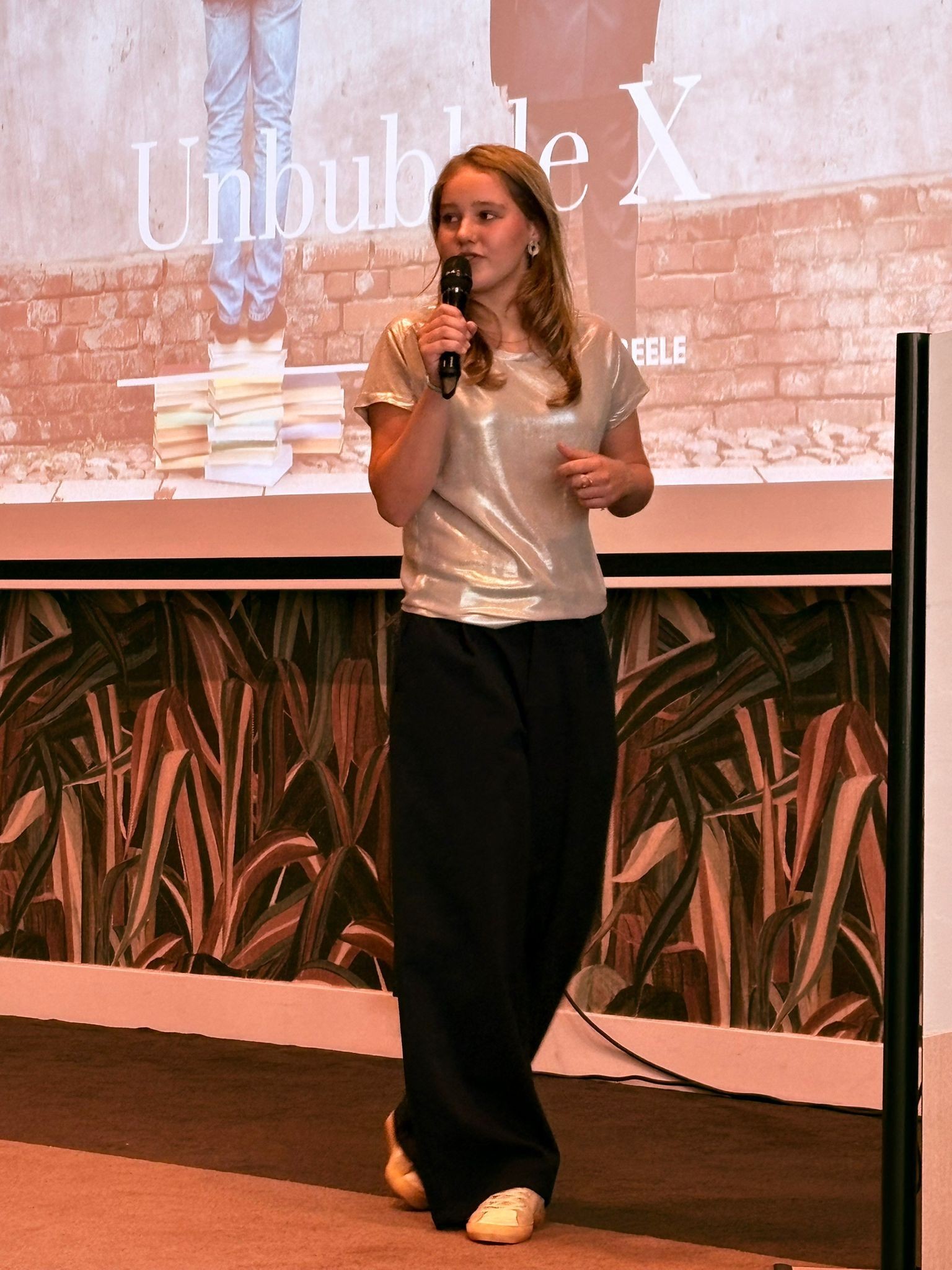 Laurine Beele speaking on stage